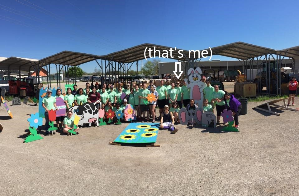 A picture taken at Bobcat Build 2015, in which Dillon helped paint wooden Easter-themed cutouts for a kids' festival.