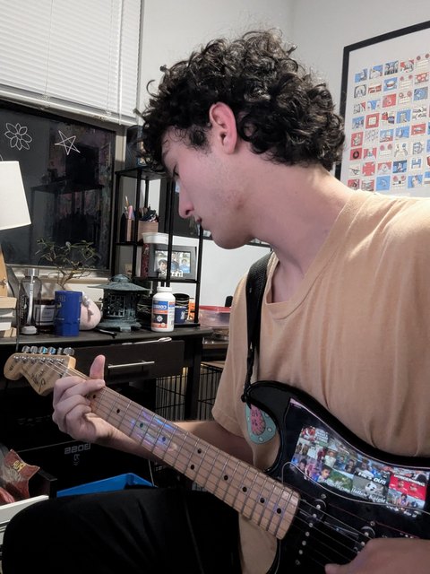 Collin Reisman playing guitar